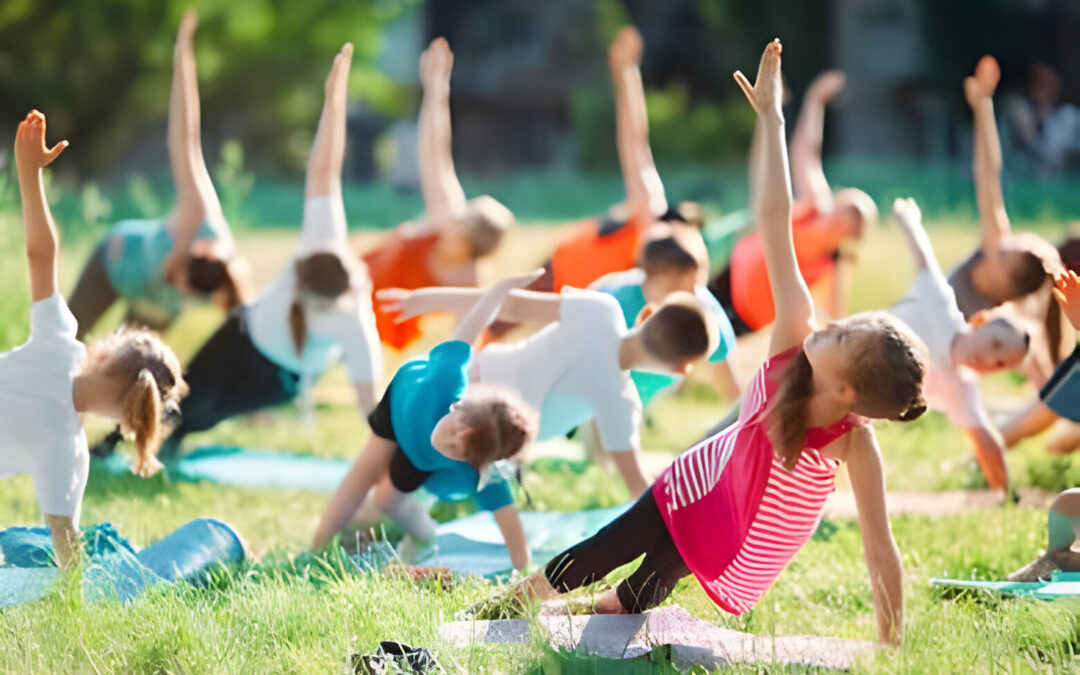 Children practicing yoga in a park, promoting wellness and mindfulness, at preschools near McKinney TX.