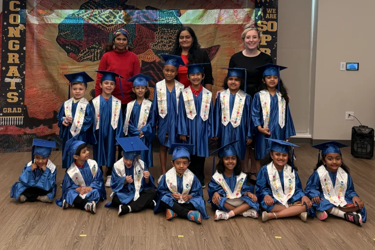 Preschool graduation ceremony with students in caps and gowns
