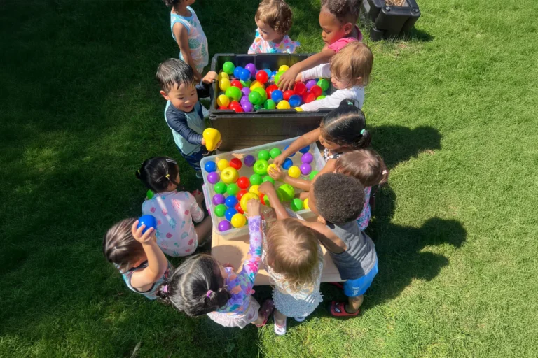 Children playing with colorful sensory balls outdoors
